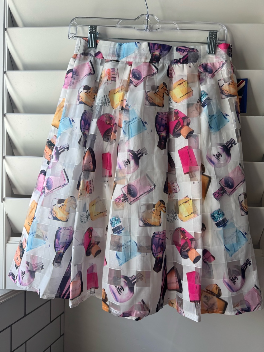 White Pleated A-Line Skirt with Multicolor Perfume Bottle Print read descrip